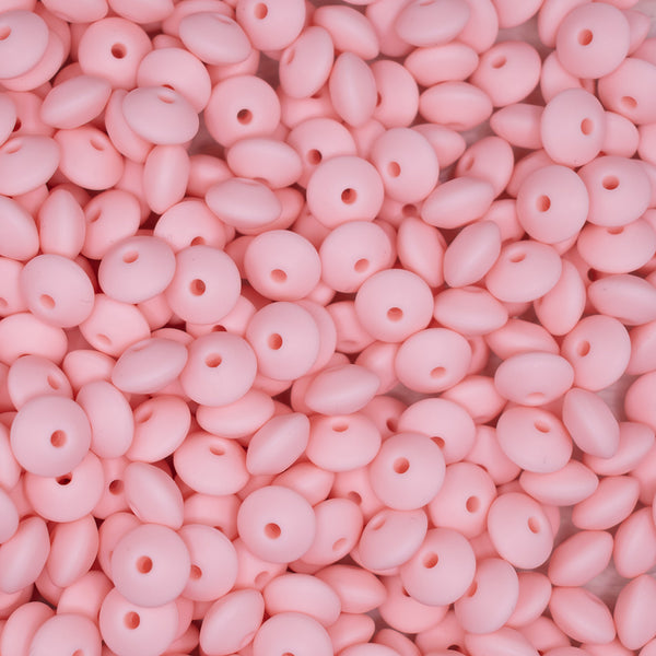 top view of a pile of 12mm Carnation Pink Lentil Silicone Bead