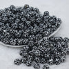 Front view of a pile of 12mm Black & White Cow Print Chunky Acrylic Bubblegum Beads - 20 Count