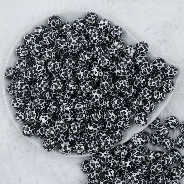 Top view of a pile of 12mm Black & White Cow Print Chunky Acrylic Bubblegum Beads - 20 Count