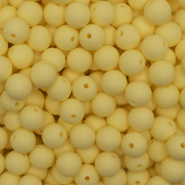 close up view of a pile of 12mm Cream Yellow Round Silicone Bead