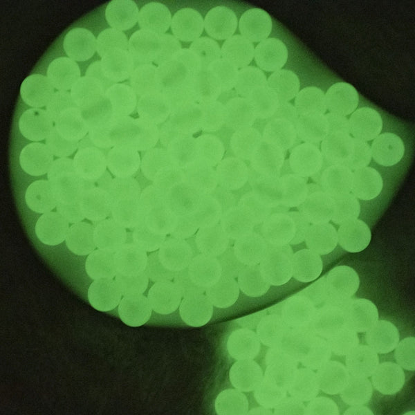 Top view of a glowing pile of 12mm Glow in the Dark Solid Bubblegum Beads [20 & 50 Count]