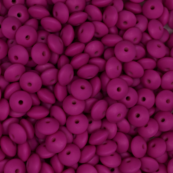 front view of a pile of 12mm Hot Pink Lentil Silicone Bead