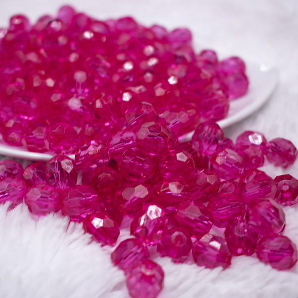 front view of a pile of 12mm Hot Pink Transparent Faceted Shaped Bubblegum Beads