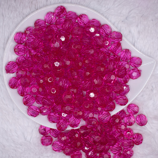 top view of a pile of 12mm Hot Pink Transparent Faceted Shaped Bubblegum Beads