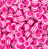 Close up view of a pile of 12mm Bright Pink with White Stripes Resin Chunky Bubblegum Beads