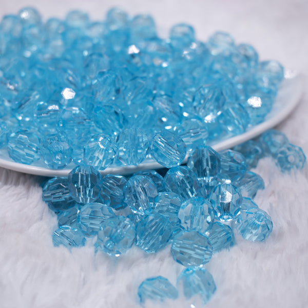 front view of a pile of 12mm Ice Blue Transparent Faceted Shaped Bubblegum Beads