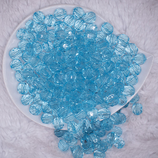 top view of a pile of 12mm Ice Blue Transparent Faceted Shaped Bubblegum Beads