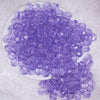 top view of a pile of 12mm Purple Transparent Faceted Shaped Bubblegum Beads