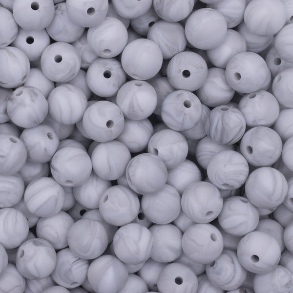 close up view of a pile of 12mm Marble White Round Silicone Bead