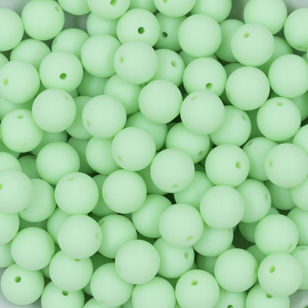 Close up view of a pile of 12mm Mint Green Matte Acrylic Bubblegum Beads