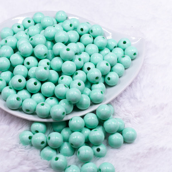 Front view of a pile of 12mm Pastel Mint Green Plaid Print Chunky Acrylic Bubblegum Beads - 20 Count