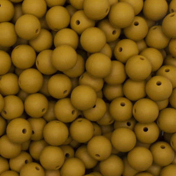 close up view of a pile of 12mm Mustard Yellow Round Silicone Bead