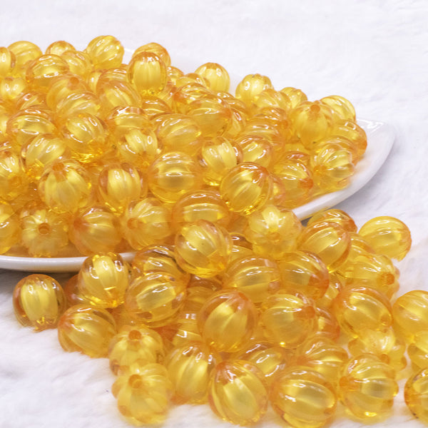 front view of a pile of 12mm Mustard Yellow Transparent Pumpkin Shaped Bubblegum Beads
