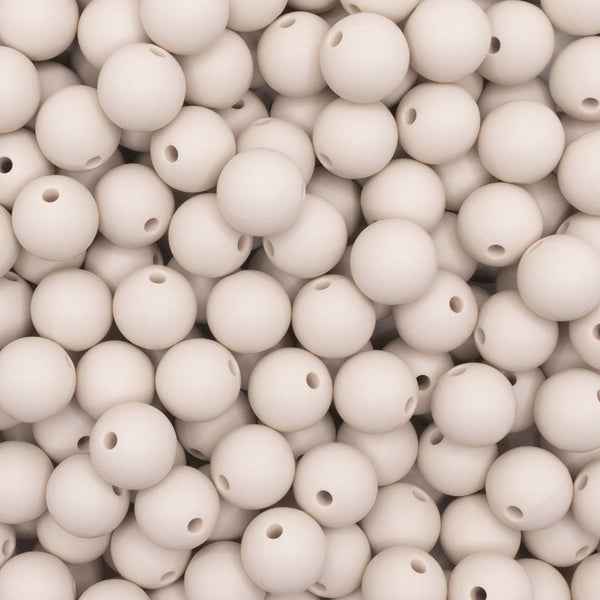 close up view of a pile of 12mm Navajo White Round Silicone Bead
