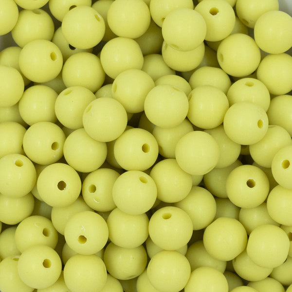 Close up view of a pile of 12mm Bright Yellow Matte Acrylic Bubblegum Beads