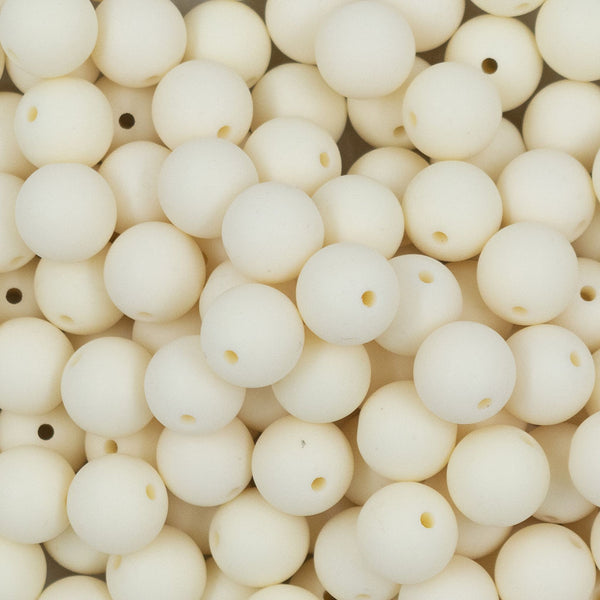 Close up view of a pile of 12mm Off White Matte Acrylic Bubblegum Beads
