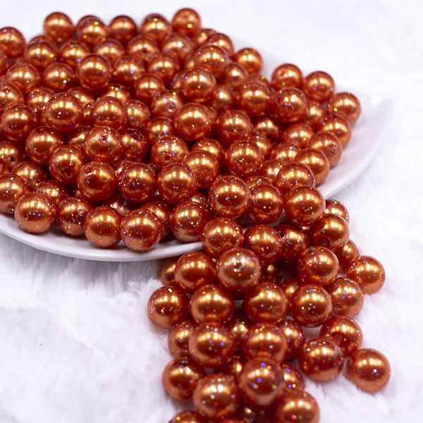 Front view of a pile of 12mm Orange with Glitter Faux Pearl Acrylic Bubblegum Beads - 20 Count