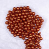 Top view of a pile of 12mm Orange with Glitter Faux Pearl Acrylic Bubblegum Beads - 20 Count