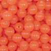 Close up view of a pile of 12mm Orange Glow in the Dark Bubblegum Beads [20 & 50 Count]