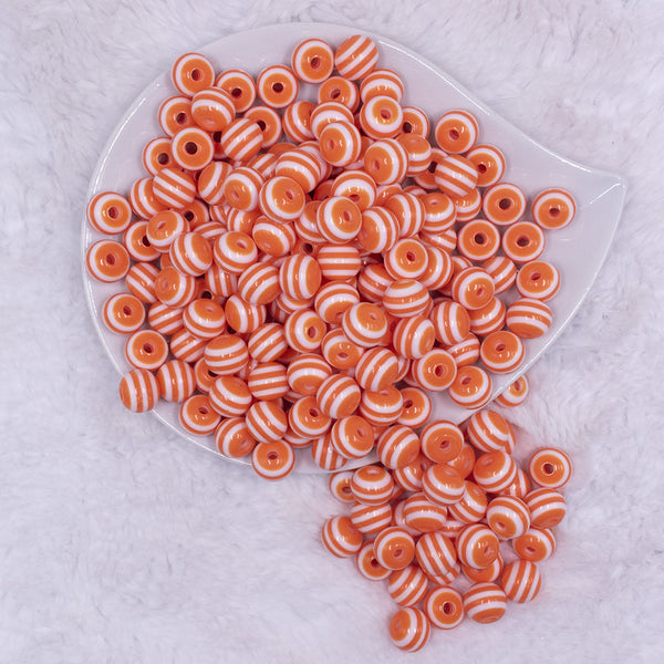 top view of a pile of 12mm Orange with White Stripes Resin Chunky Bubblegum Beads