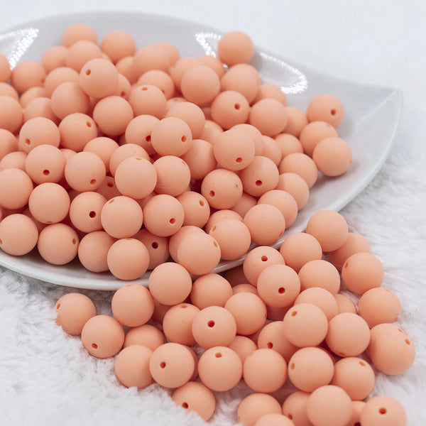 Front view of a pile of 12mm Peach Matte Acrylic Bubblegum Beads