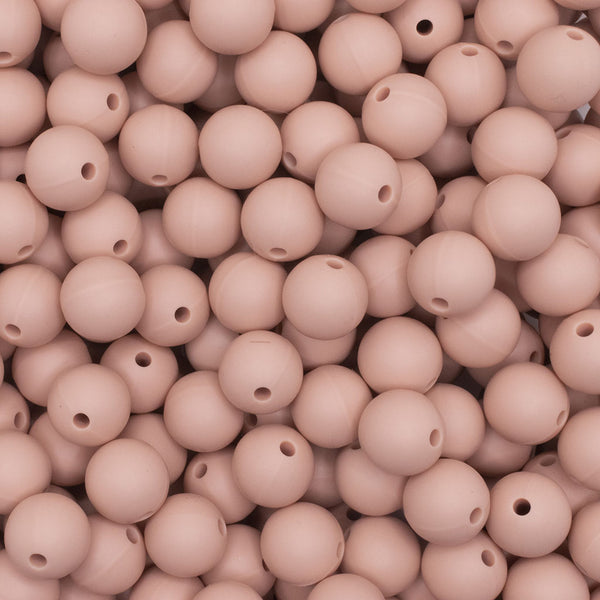 close up view of a pile of 12mm Peach Round Silicone Bead