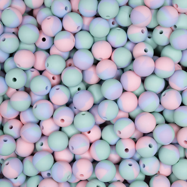 top view of a pile of 12mm Pink and Blue Tie Dyed Round Silicone Bead