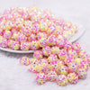 front view of a pile of 12mm Pink and Yellow Confetti Rhinestone AB Bubblegum Beads -10 & 20 Count