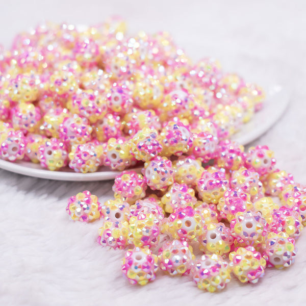front view of a pile of 12mm Pink and Yellow Confetti Rhinestone AB Bubblegum Beads -10 & 20 Count