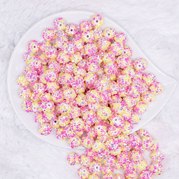 top view of a pile of 12mm Pink and Yellow Confetti Rhinestone AB Bubblegum Beads -10 & 20 Count