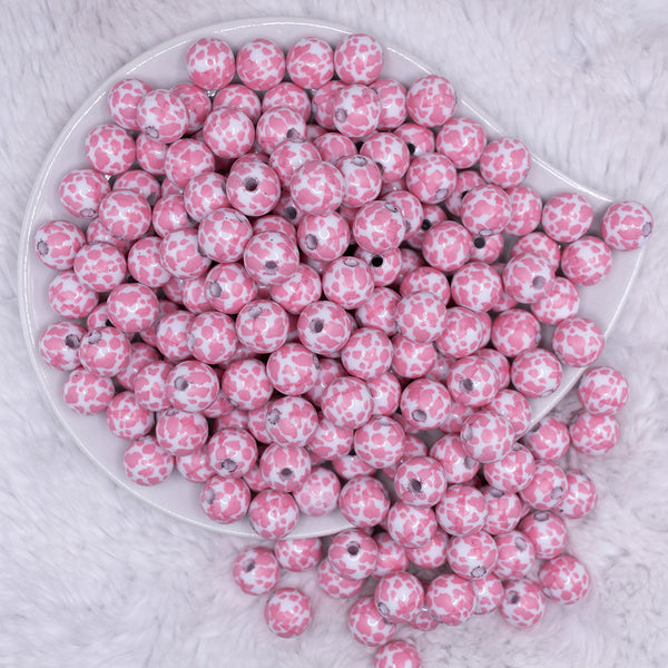 top view of a pile of 12mm Pink & White Cow Print Chunky Acrylic Bubblegum Beads - 20 Count