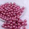 Front view of a pile of 12mm Pink with Glitter Faux Pearl Acrylic Bubblegum Beads - 20 Count