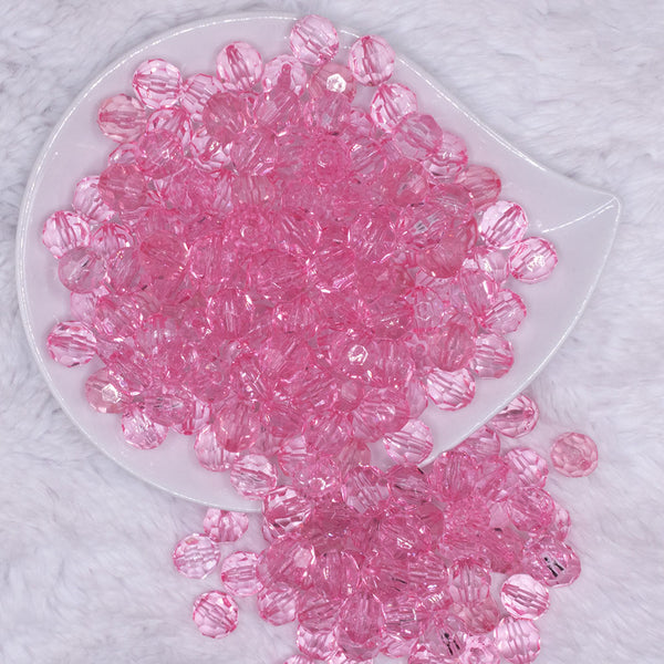 top view of a pile of 12mm Pink Transparent Faceted Shaped Bubblegum Beads