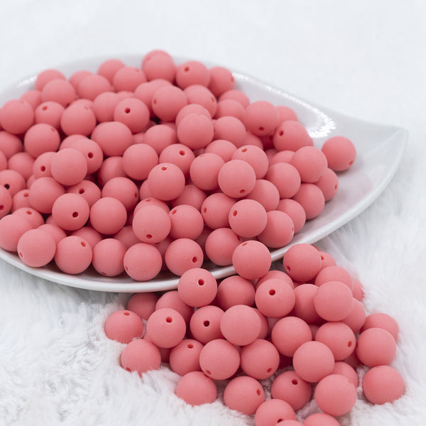 Front view of a pile of 12mm Punch Pink Matte Acrylic Bubblegum Beads