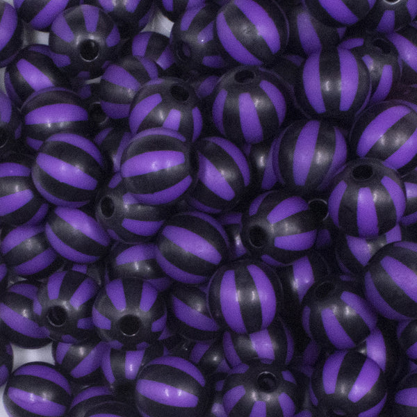 close up view of a pile of 12mm Purple with Black Stripe Beach Ball Bubblegum Beads