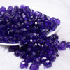 front view of a pile of 12mm Dark Purple Transparent Faceted Shaped Bubblegum Beads