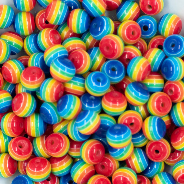 Close up view of a pile of 12mm Thick Rainbow Stripes Resin Chunky Bubblegum Beads