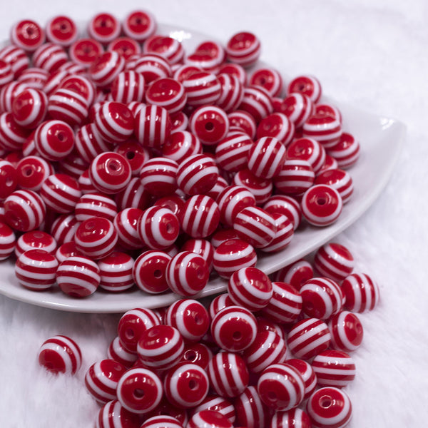 Front view of a pile of 12mm Red with White Stripes Resin Chunky Bubblegum Beads