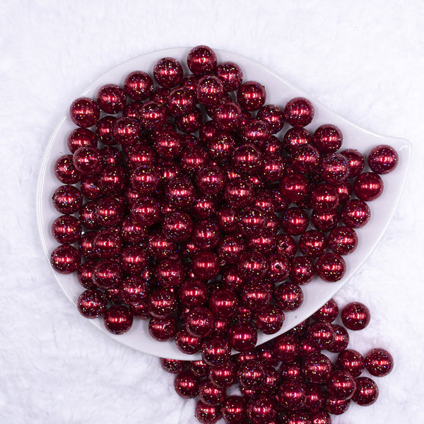 Top view of a pile of 12mm Red with Glitter Faux Pearl Acrylic Bubblegum Beads - 20 Count