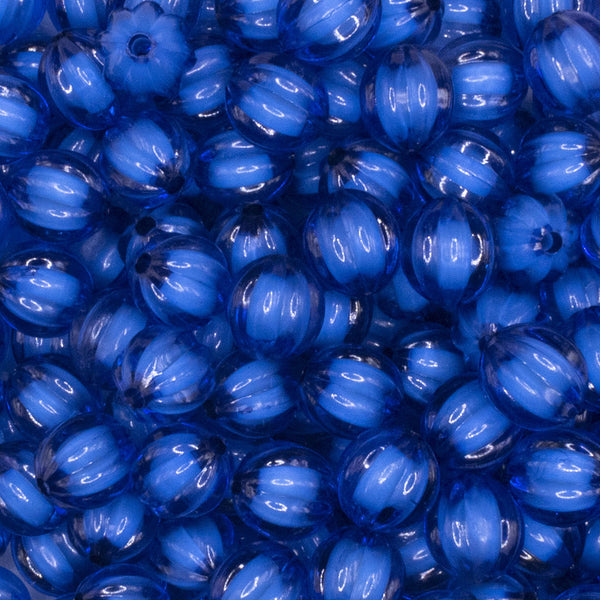 Close up view of a pile of 12mm Royal Blue Transparent Pumpkin Shaped Bubblegum Beads