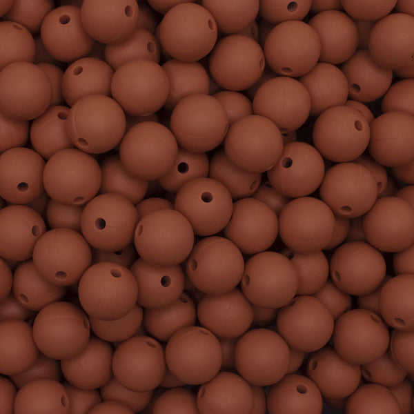 close up view of a pile of 12mm Rust Brown Round Silicone Bead