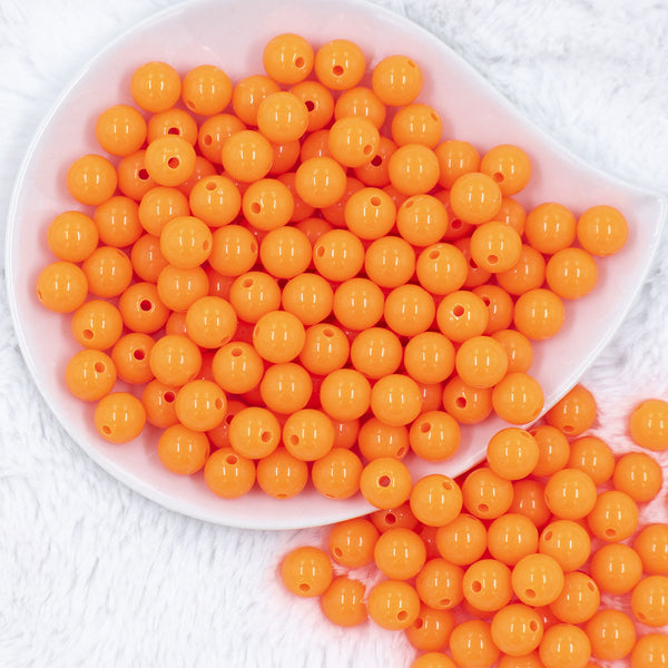 Top view of a pile of 12mm Safety Orange Acrylic Bubblegum Beads [20 & 50 Count]Front view of a pile of 12mm Safety Orange Acrylic Bubblegum Beads [20 & 50 Count]