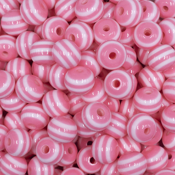 Close up view of a pile of 12mm Salmon Pink with White Stripes Resin Chunky Bubblegum Beads