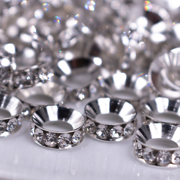 Front view of a pile of 12mm Silver Rondelle Spacer Beads - Large hole [Set of 10]