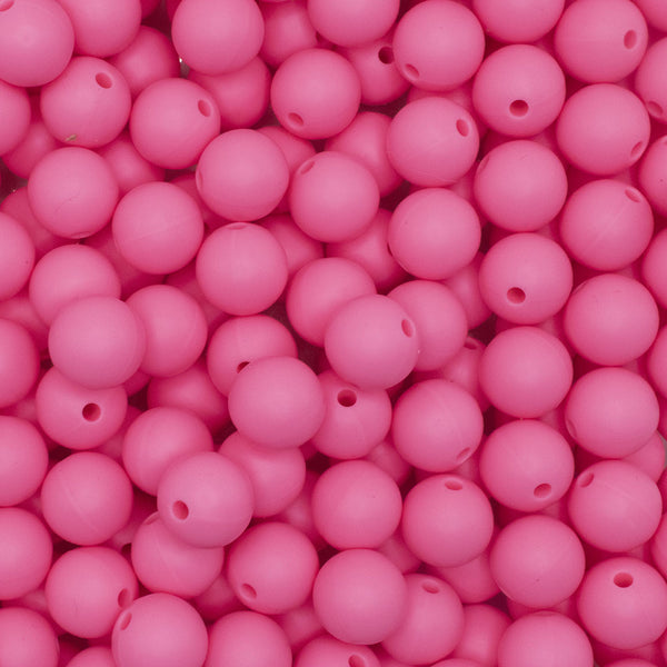Close up view of a pile of 12mm Sakura Pink Round Silicone Bead