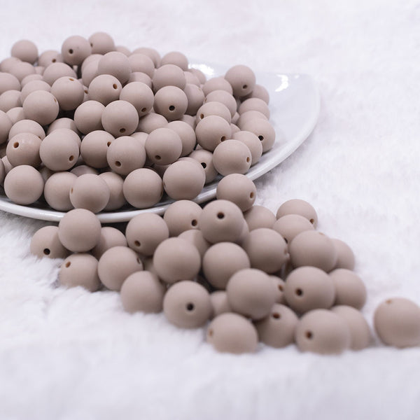 Front view of a pile of 12mm Tan Matte Acrylic Bubblegum Beads