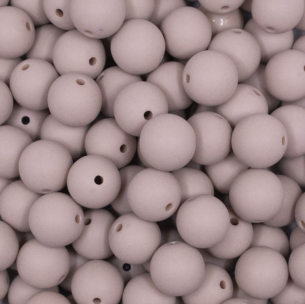 Close up view of a pile of 12mm Tan Matte Acrylic Bubblegum Beads