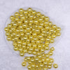 Top view of a pile of 12mm Yellow with Glitter Faux Pearl Acrylic Bubblegum Beads - 20 Count