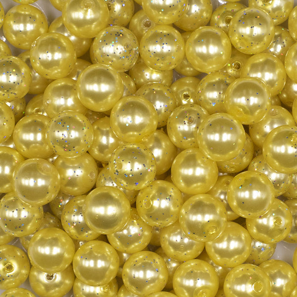 Close up view of a pile of 12mm Yellow with Glitter Faux Pearl Acrylic Bubblegum Beads - 20 Count