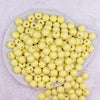 Top view of a pile of 12mm Pastel Yellow Plaid Print Chunky Acrylic Bubblegum Beads - 20 Count